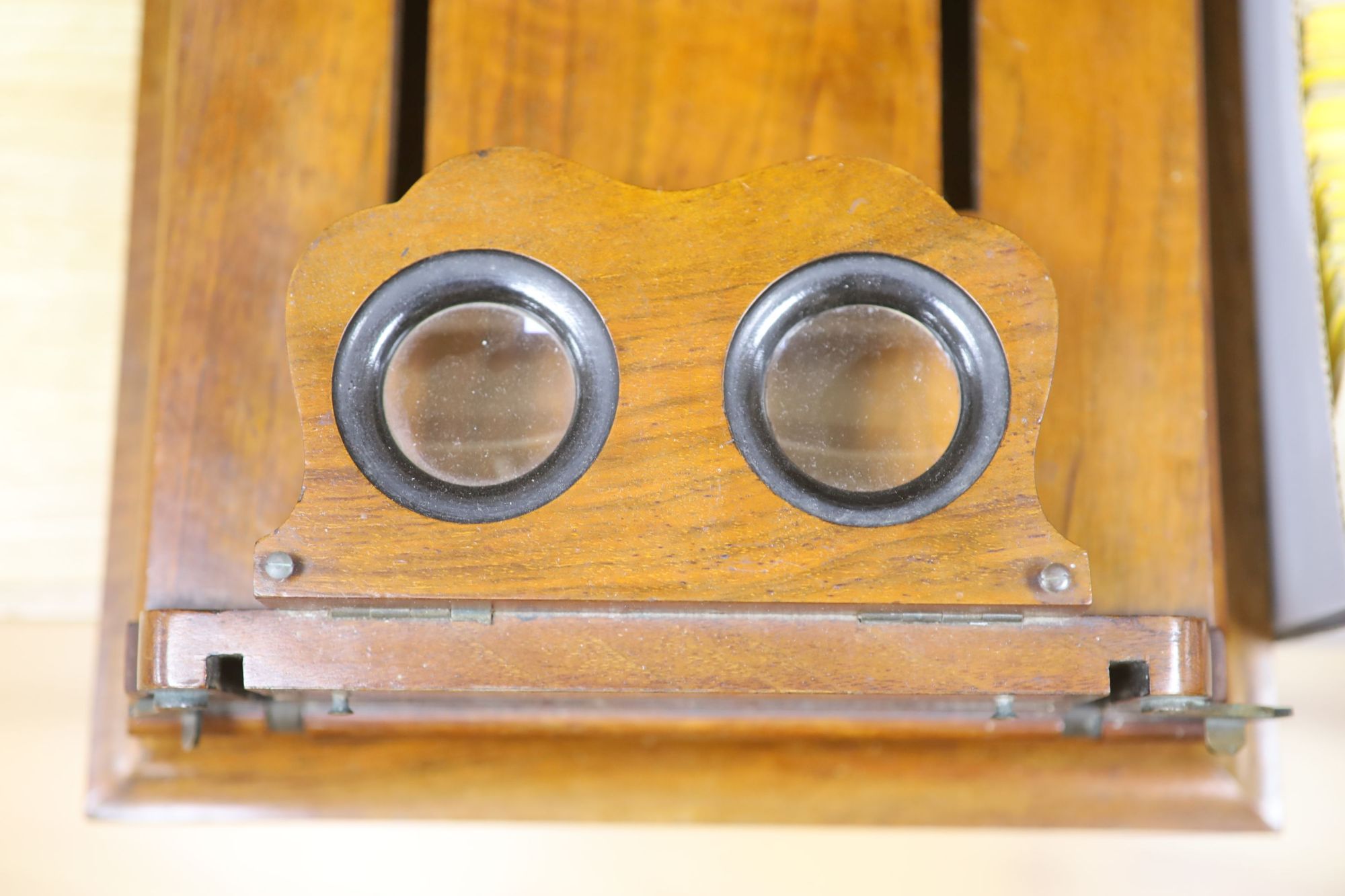 A large Victorian walnut stereoscopic card viewer with slides, Football at Eton etc, length 58cm width 30cm height 28cm